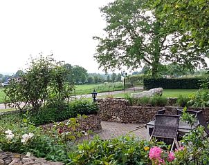 Enjoy rural views from the terrace of Huisje in Mechelen, a charming vacation home in South Limburg surrounded by nature.