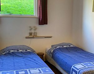 Slaapkamer met uitzicht op de tuin in Vakantiehuis in Wijlre, Zuid Limburg.