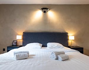 Luxurises Bett mit Nachtlicht in einem Ferienhaus in Epen, Sdlimburg, Komfort und Stil kombiniert.