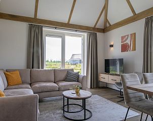 Gezellige woonkamer in Villa 6B, vakantiehuis in Someren, met comfortabele zithoek en uitzicht op De Peel.