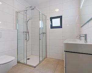 Ronde eettafel in vakantiehuis 20-persoonsbungalow 20L, Someren, De Peel, Noord Brabant met tuinzicht.