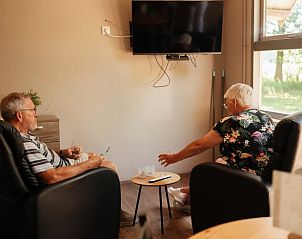 Cozy together in the living room of Holiday Home in Bergeijk, overlooking the garden.