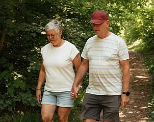 Couple enjoy a walk in the green surroundings of Holiday home in Bergeijk, Kempen.