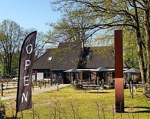 Outdoor seating and open atmosphere at Holiday Home in Bergeijk, ideal for a sunny day.