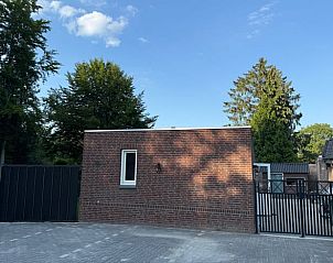 Auenansicht des Ferienhauses in Luyksgestel, Kempen, mit eingezuntem Garten und Eingangstor.