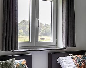 Uitzicht op natuur vanuit slaapkamer in Vakantiehuisje in Hapert, Kempen, Noord Brabant.