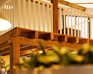 Wooden details and plants in the loft of Huisje in Moergestel, vacation home in Moergestel, North Brabant.