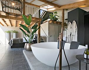 Spacious bedroom in Holiday home in Moergestel, North Brabant, with wooden beams and comfortable bed.