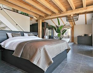 Stylish bathroom in Holiday Home in Moergestel, Heart of Brabant, with designer bathtub and glass shower.