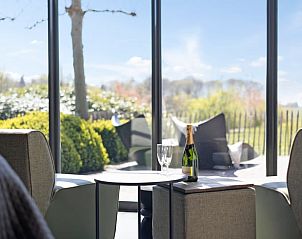 Cozy sitting area with view in Holiday home in Moergestel, North Brabant, perfect for relaxation.