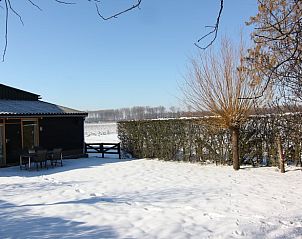 Sneeuwbedekte tuin van Vakantiehuisje in Hank, winterse charme in Hart van Brabant, Noord Brabant.