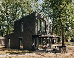 Patio 4 vakantiehuis in Schaijk, Noordoost Brabant, omgeven door groene natuur en voorzien van een uitnodigend terras voor ontspanning.