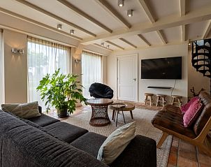 Gezellige zithoek met televisie in Vakantiehuis in Oeffelt, Noordoost Brabant, perfect voor ontspanning.