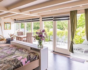Lichte en ruime slaapkamer in Vakantiehuis in Oeffelt, Noord Brabant, met toegang tot het zonnige balkon.