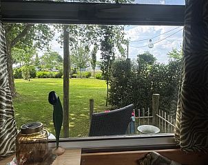 Prachtig uitzicht op de tuin vanuit de woonkamer van Huisje in Sint Anthonis, Noord Brabant, met veel licht.