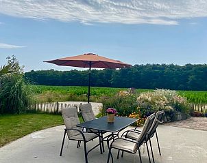 Vacation home in Callantsoog with terrace view of green meadows, North Sea coast, North Holland.