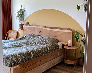 Rustic bedroom with wooden bed in Holiday home in Callantsoog, North Sea coast, North Holland.