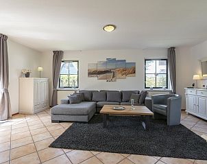 Comfortable living room of Buitenplaats 100 Callantsoog vacation home in North Holland with modern furnishings.