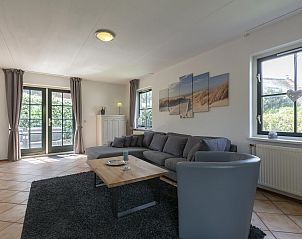 Bright living room of Buitenplaats 100 Callantsoog vacation home in North Holland with access to the garden.