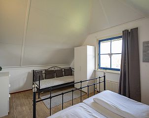 Cozy bedroom with extra bed in Buitenplaats 100 Callantsoog vacation home in North Holland.