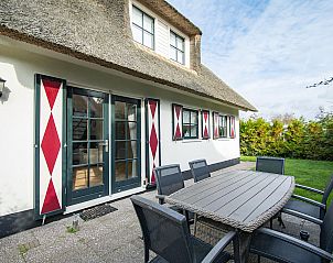 Spacious terrace of Buitenplaats 100 Callantsoog vacation home on the North Sea coast in North Holland, ideal for outdoor dining.