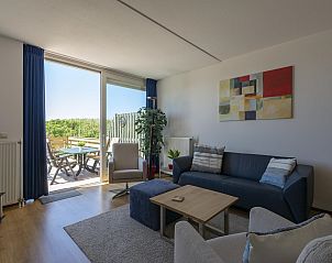 Bright living room with terrace at Duinerei C002 Groote Keeten vacation home in Callantsoog, North Sea coast, North Holland.