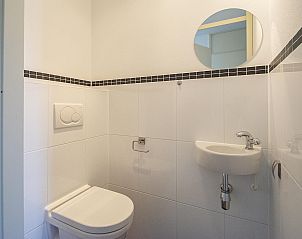 Compact toilet in Duinerei C103 Groote Keeten vacation home in Callantsoog, North Holland.
