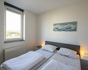 Bedroom with double bed in Duinerei C103 Groote Keeten vacation home in Callantsoog, North Holland.