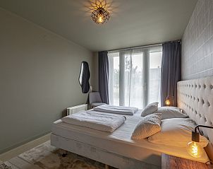 Comfortable bedroom in Strandleven 006 Groote Keeten, Callantsoog, overlooking the garden.