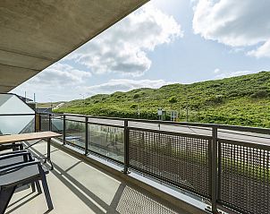Sunny terrace with dune view at Wijde Blick 112 Callantsoog, vacation home on the North Sea coast, North Holland.