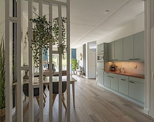 Open kitchen and dining area in Wijde Blick 112 Callantsoog, vacation home on the North Sea coast.