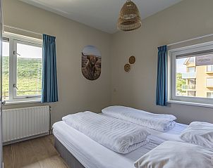 Bedroom overlooking dunes in Wijde Blick 112 Callantsoog, vacation home on the North Sea coast.