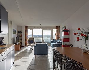 Cozy living area of Wijde Blick 205 Callantsoog, overlooking North Sea coast, perfect for family vacations.