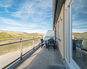 Zonnig balkon van Wijde Blick 310 Callantsoog met uitzicht op de duinen, Noord-Holland