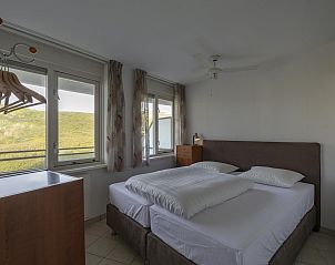 Spacious bedroom with a view in Wijde Blick 208 Callantsoog, vacation home on the North Sea coast.