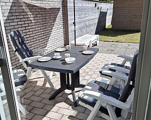 Outdoor terrace with parasol at vacation home NH057, Callantsoog, North Sea coast, North Holland.