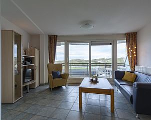 Cozy living room in vacation home Wijde Blick 206 Callantsoog on the North Sea coast, overlooking dunes.