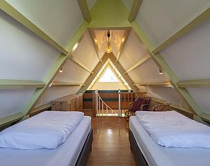 Attic room with beds in Sandepark 093 Groote Keeten vacation home in Callantsoog, North Holland.