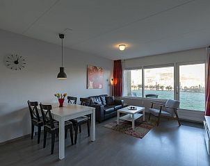 Cozy dining area in Beach Apartment 08 Callantsoog overlooking the garden.