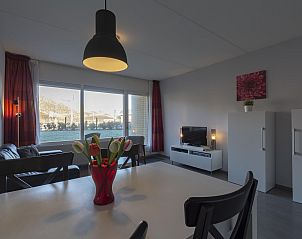 Stylish dining area in Beach Apartment 08 Callantsoog overlooking the garden.