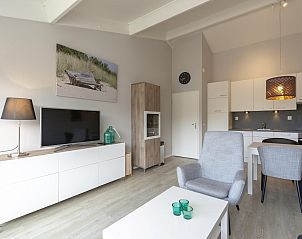 Stylish interior space of Beach Apartment 35 Callantsoog with dining area and kitchen.