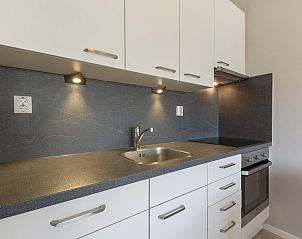 Sleek kitchen of Beach Apartment 35 Callantsoog with modern appliances.