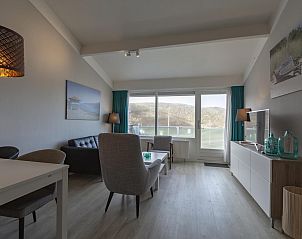 Bright living room of Beach Apartment 35 Callantsoog with modern furnishings.