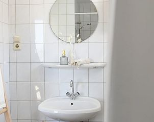 Cozy table set at Holiday Home in Callantsoog, North Sea Coast, North Holland with fresh bread and fruit.
