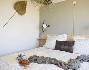 Stylish living room in Holiday Home in Callantsoog, North Sea Coast, North Holland with modern decor and lots of natural light.