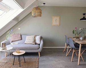 Outdoor seating surrounded by flowers at Holiday home in Callantsoog, North Sea coast, North Holland for cozy evenings.