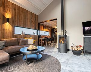 Interior of Spoelde wheel vacation home in Callantsoog with comfortable sitting area and warm atmosphere.