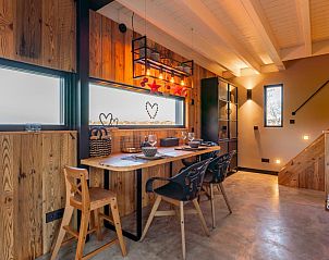 Dining table in Spoelde wheel vacation home in Callantsoog with atmospheric lighting and view.