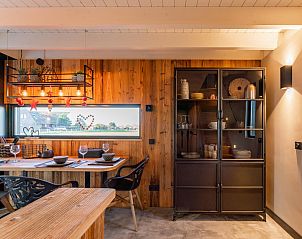 Cozy dining room in Spoelde wheel vacation home in Callantsoog with wooden furniture.
