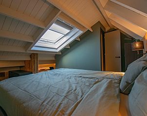 Bedroom in Spoelde wheel vacation home in Callantsoog with skylight and comfortable bed.